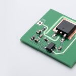 P-channel MOSFET high-side switch controlled by a small N-MOSFET driver on a clean PCB